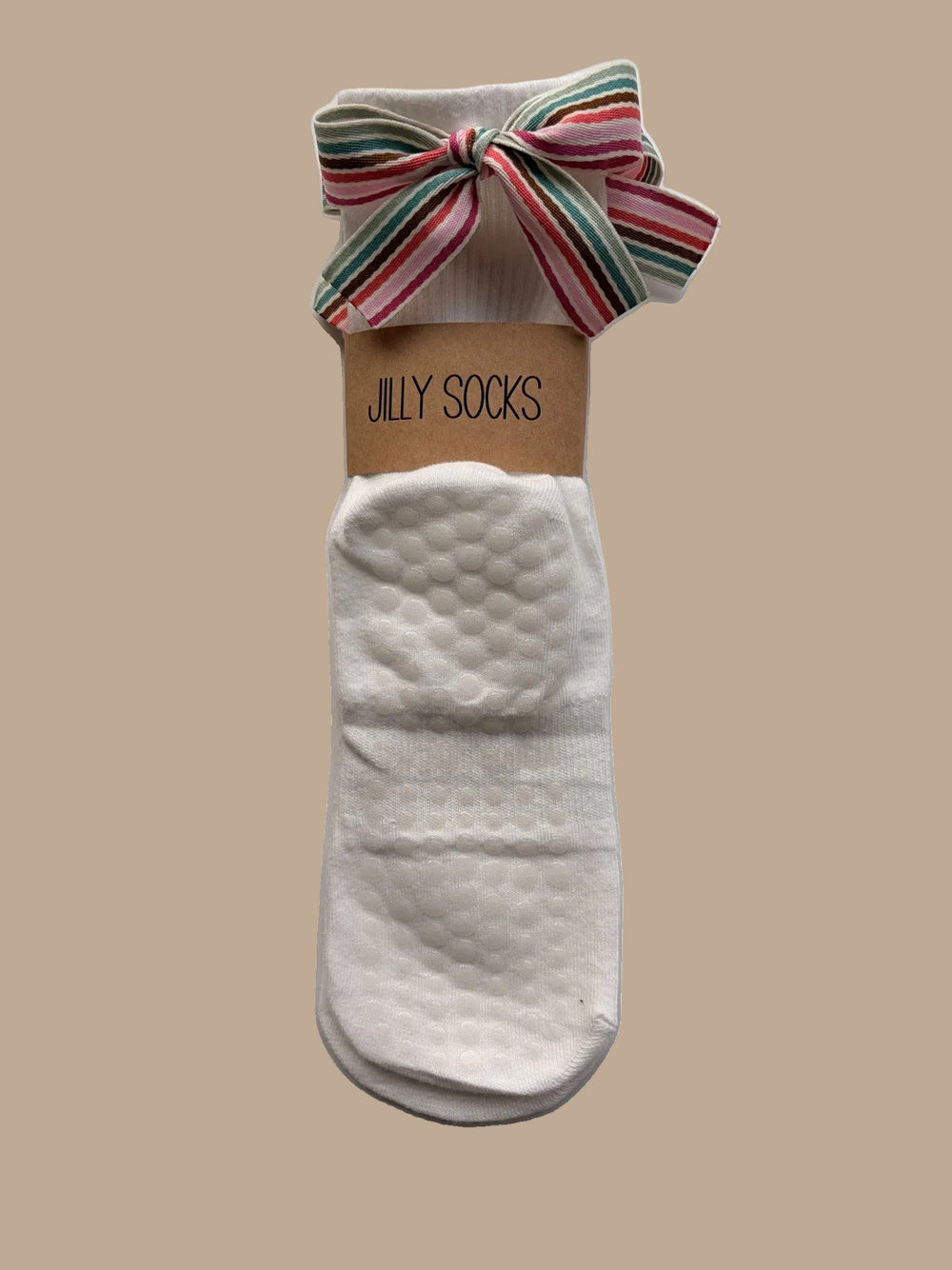 Cute, fashionable off-white Pilates grip sock with a bright color stripes bow on mannequin feet and a white background.